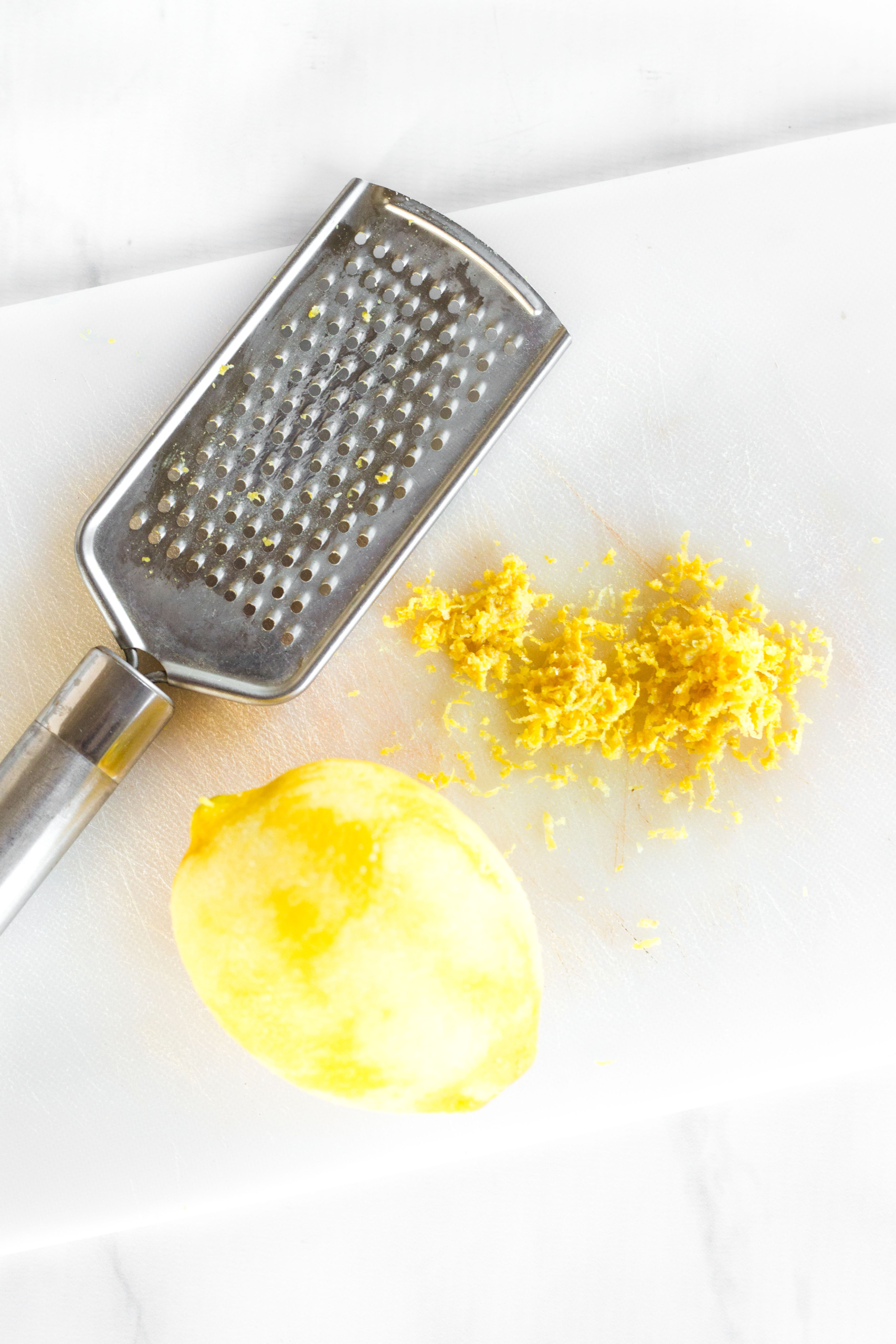 Freshly grated lemon zest on cutting board.