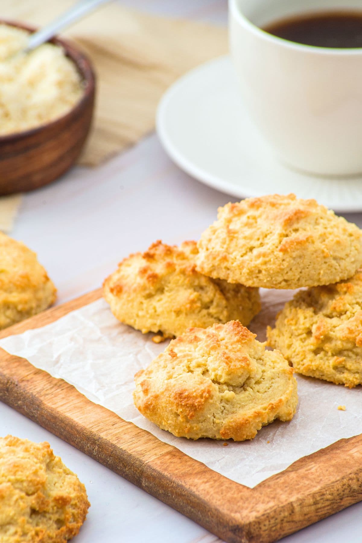 Almond flour biscuits on parchment-lined wooden board