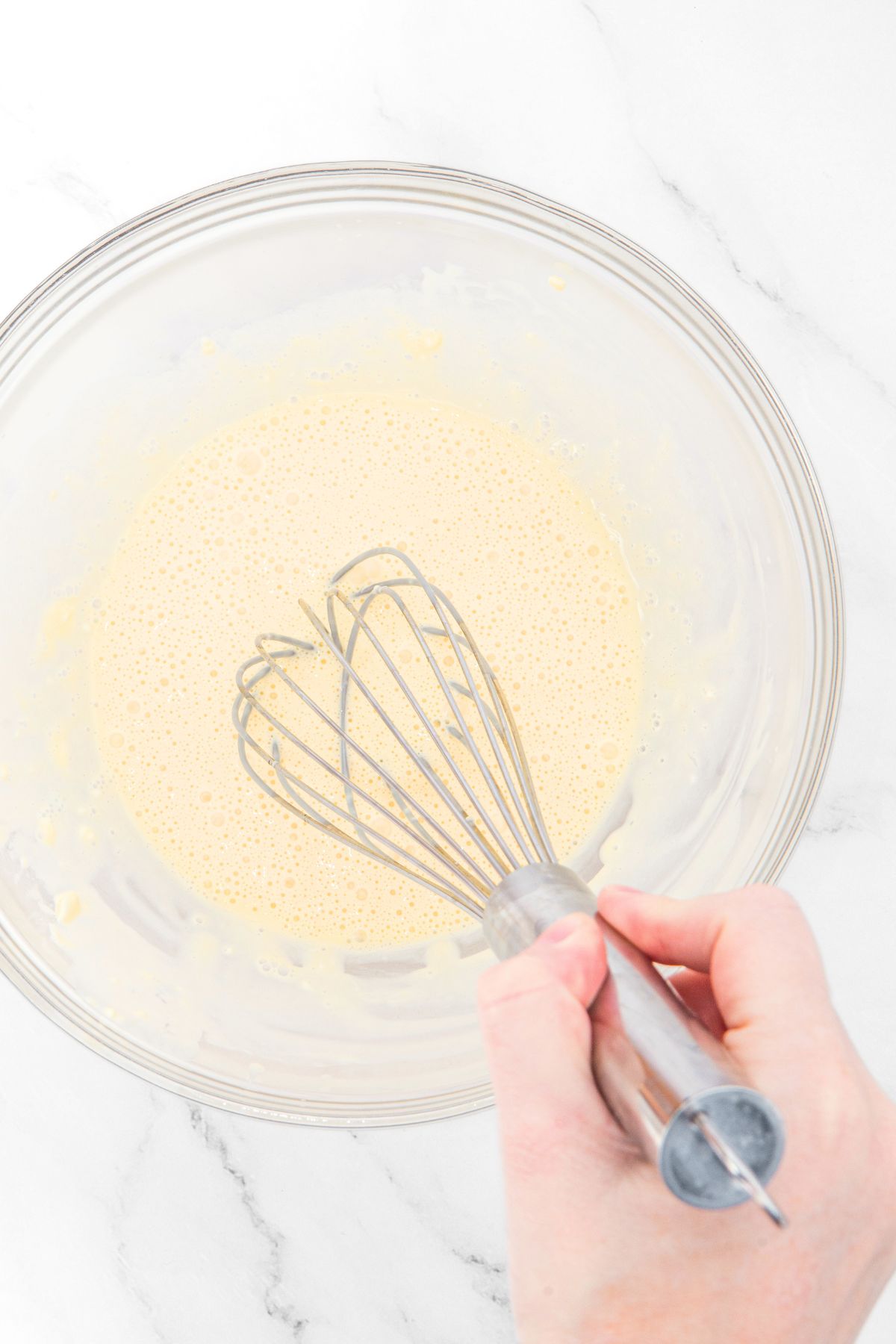 Whisking pale yellow batter bowl