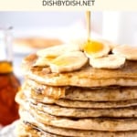 Drizzling maple syrup on a stack of gluten-free banana pancakes.