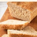 Sliced loaf of beer bread (gluten-free) on wooden board.