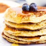 A stack of cottage cheese pancakes drizzled in maple syrup