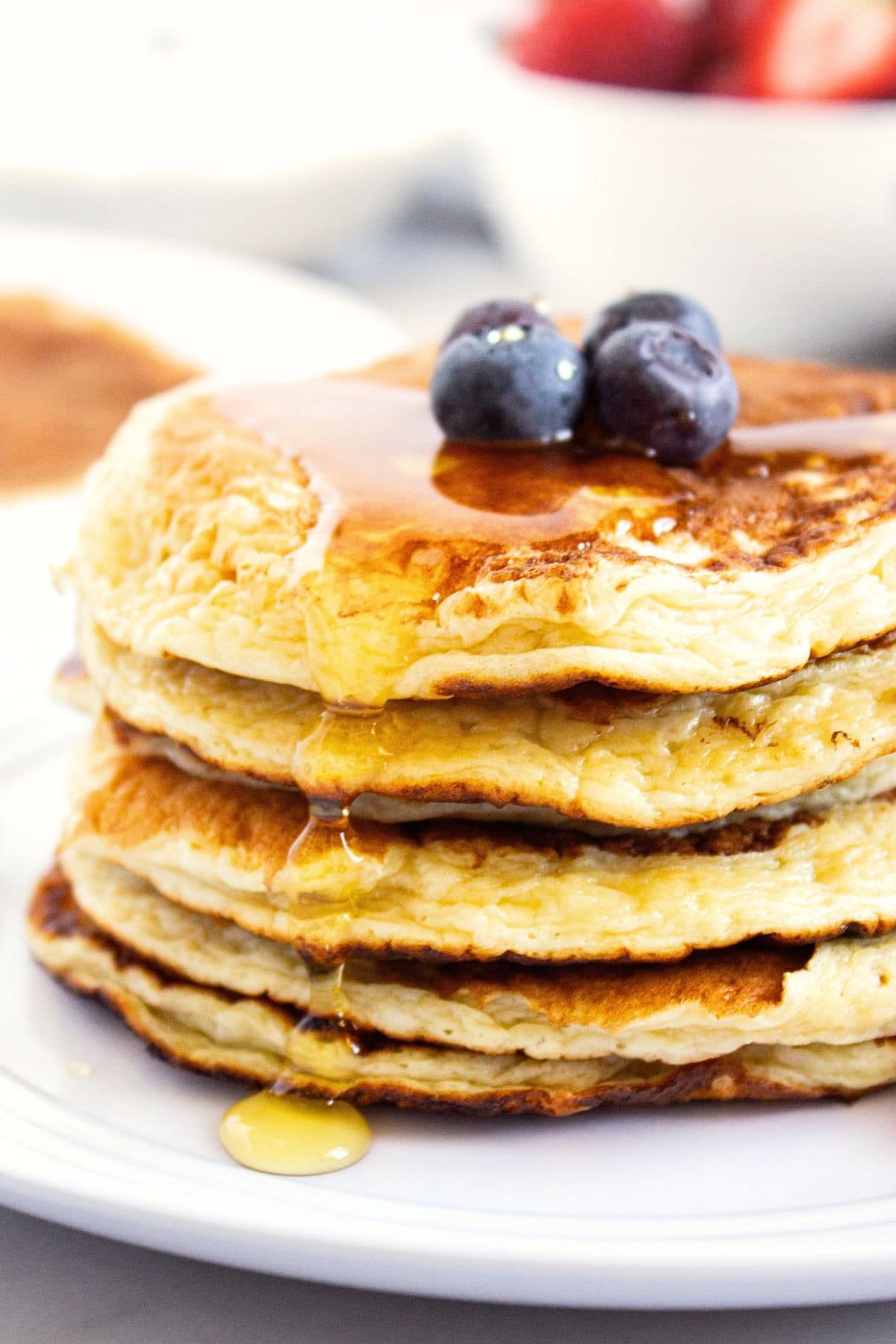 A stack of cottage cheese pancakes (gluten-free) topped with blueberries.