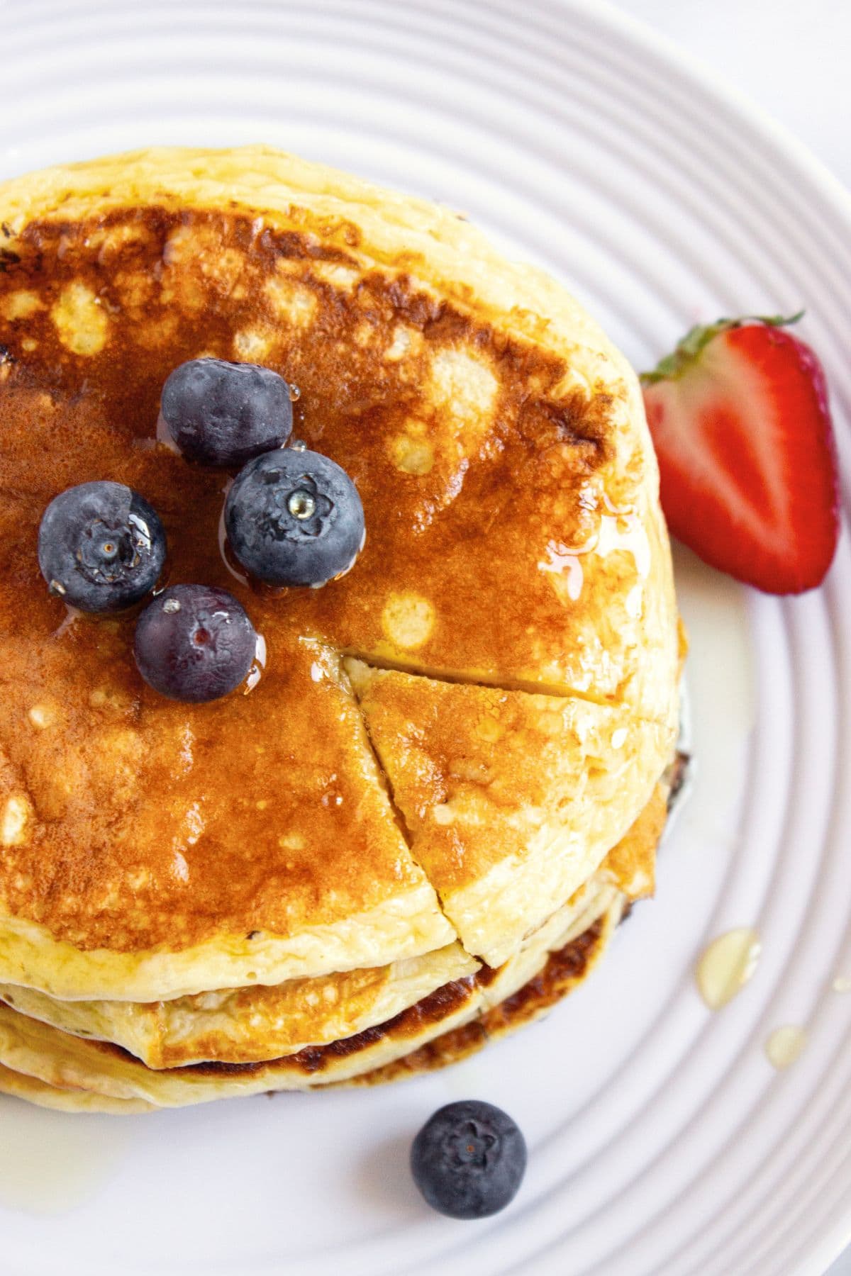 Top down view of stack of pancakes with fresh berries