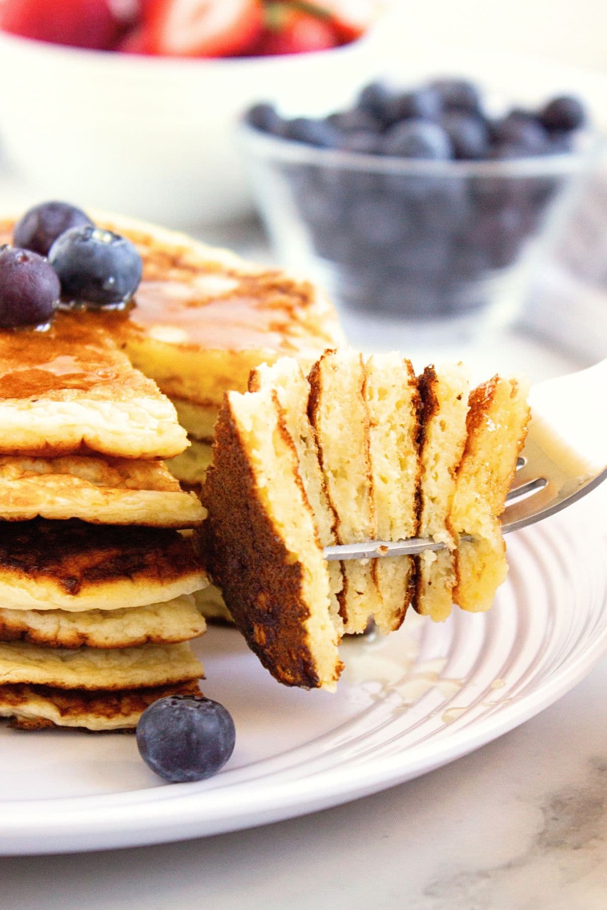 Holding up a forkful of cottage cheese pancakes.
