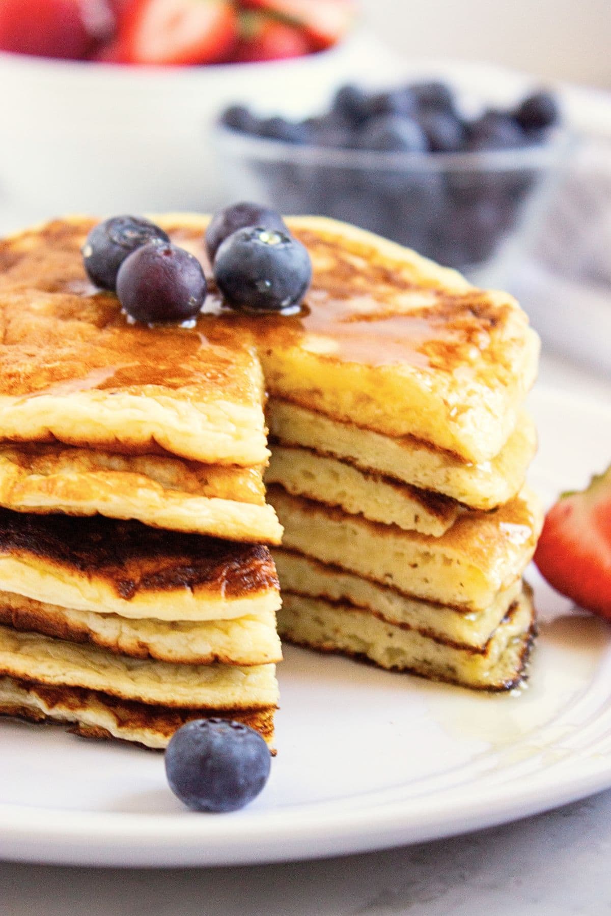 Half-eaten stack of cottage cheese pancakes