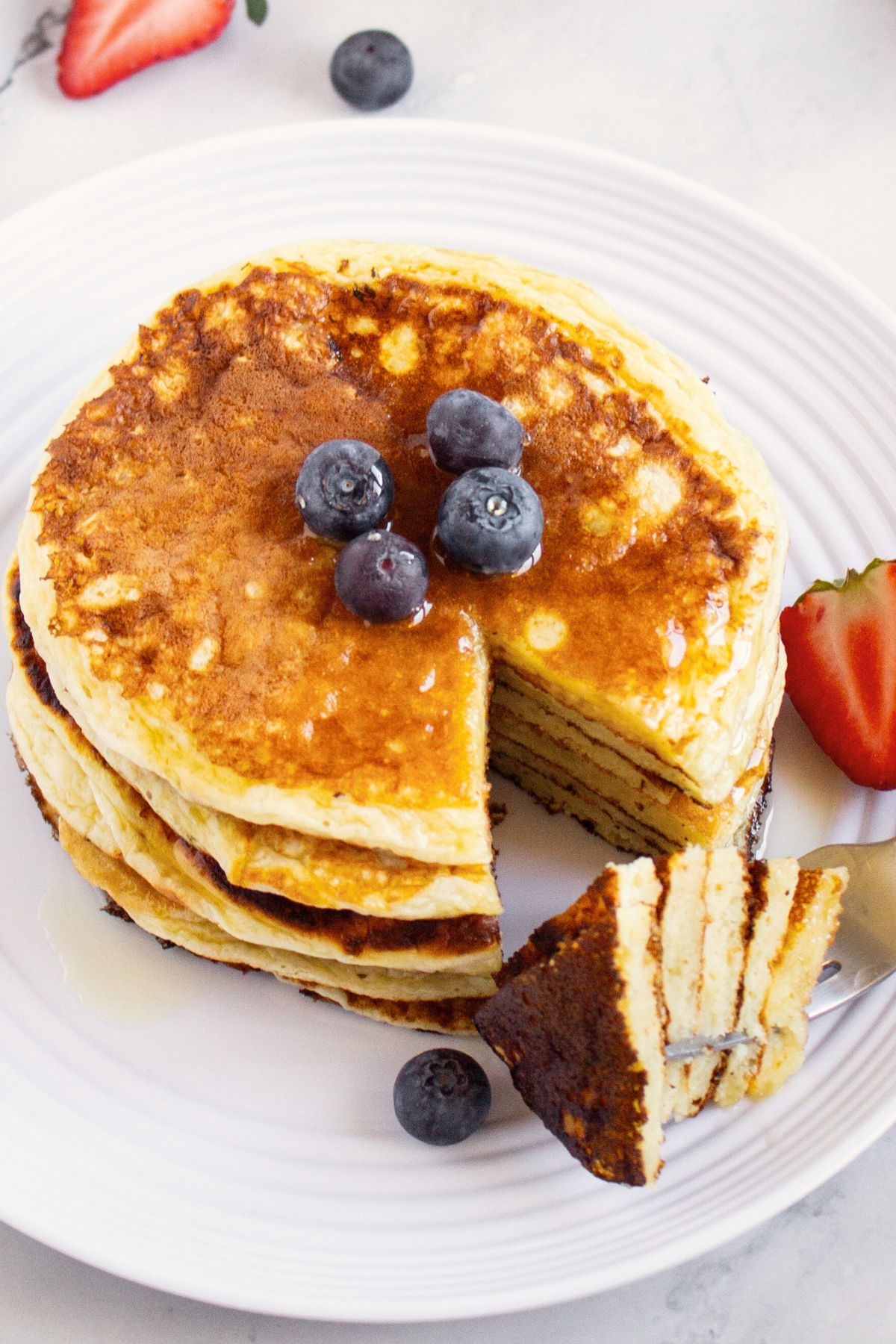 Half-eaten stack of cottage cheese pancakes