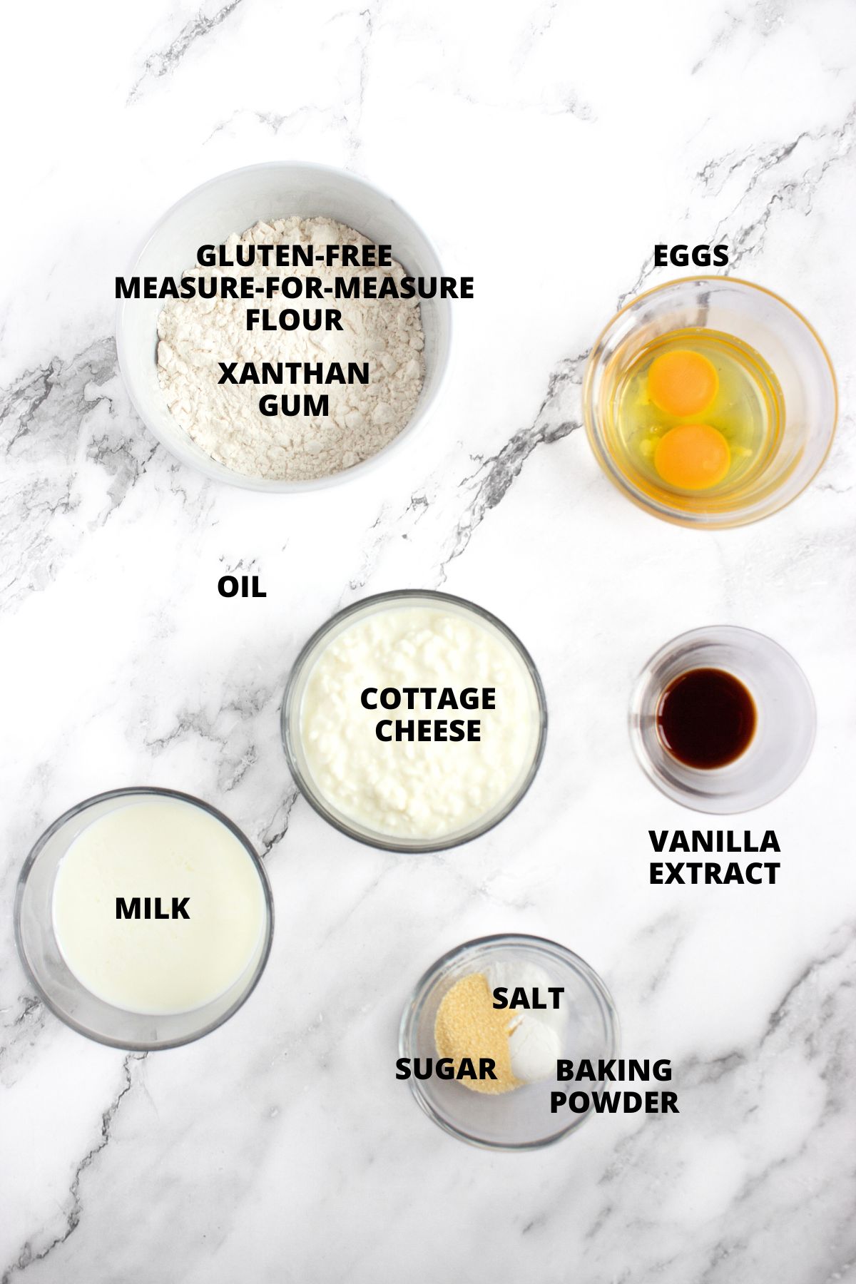Ingredients for gluten-free cottage cheese pancakes recipe laid out on marble board.