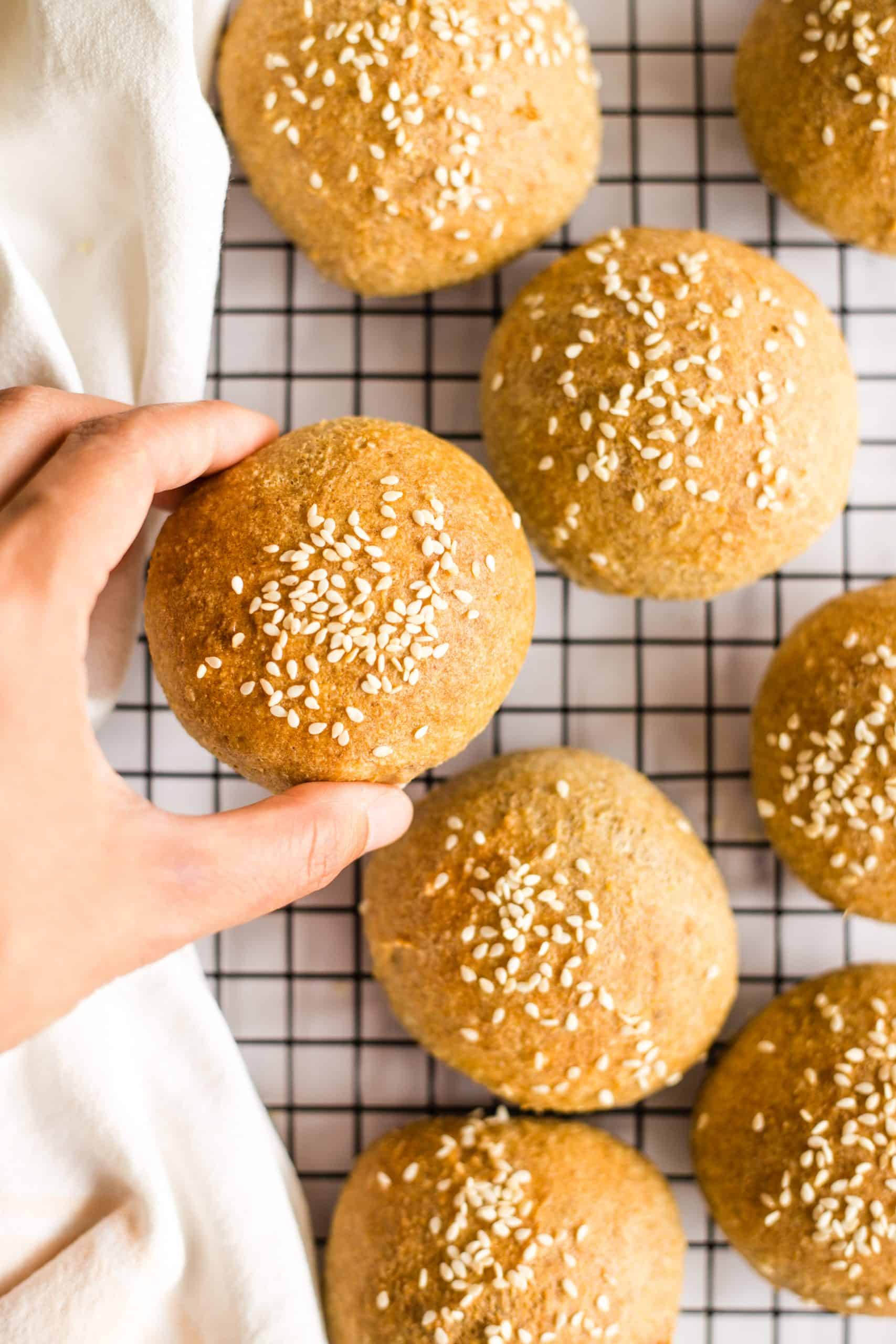 Hand holding up a gluten-free low carb bun.