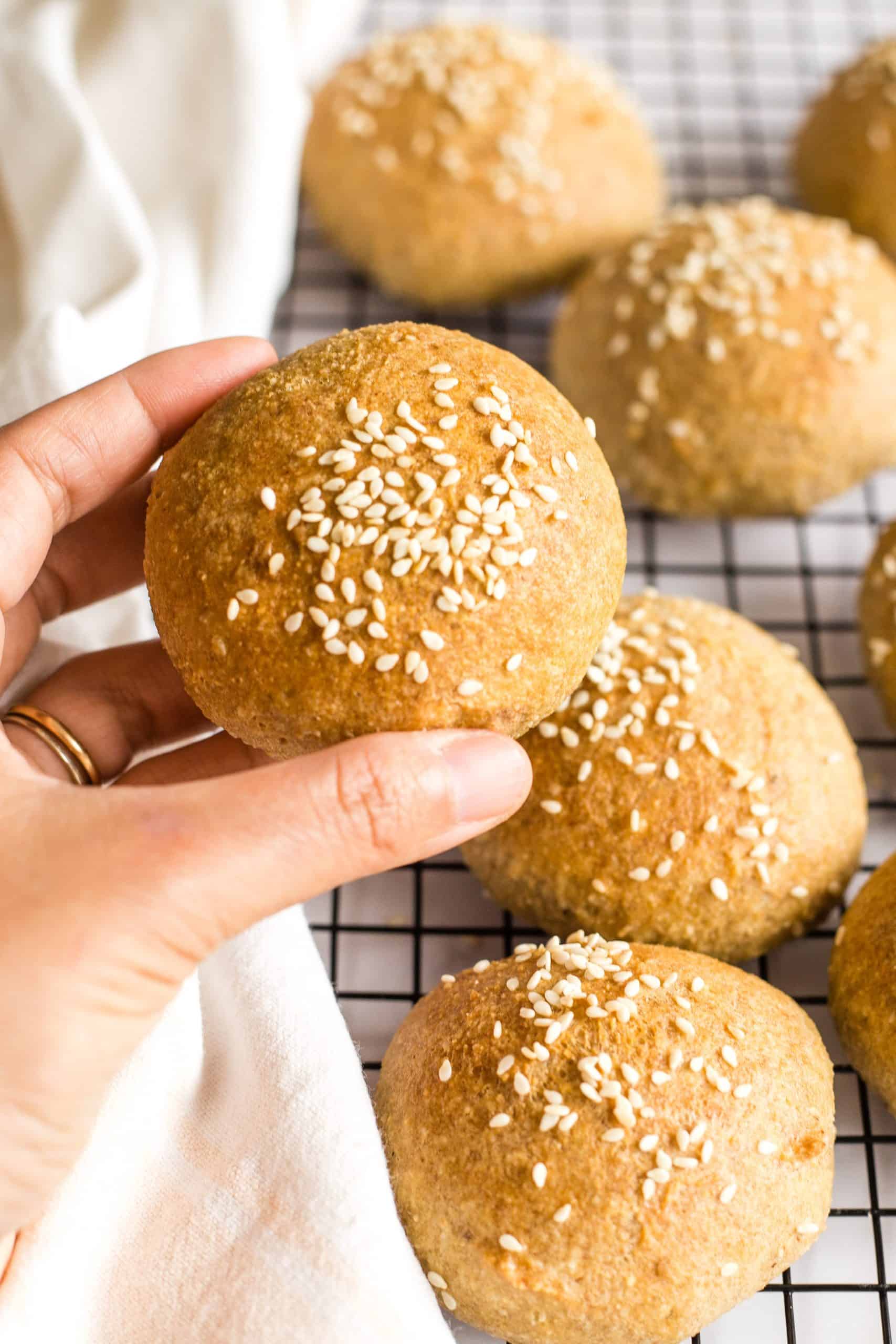 Hand holding up a gluten-free bun.