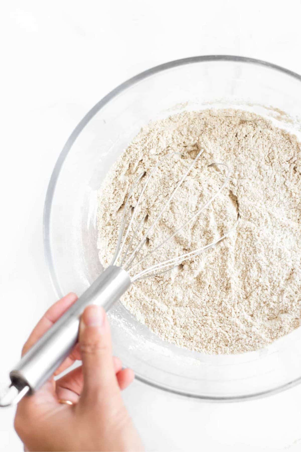 Whisking flour mixture in glass bowl.