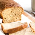Up close shot of a half-sliced loaf of quinoa bread.