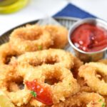 Gluten-free calamari rings dipped in marinara sauce.