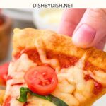 Hand holding up a slice of pizza