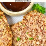 Pieces of pecan crusted chicken and a bowl of sauce