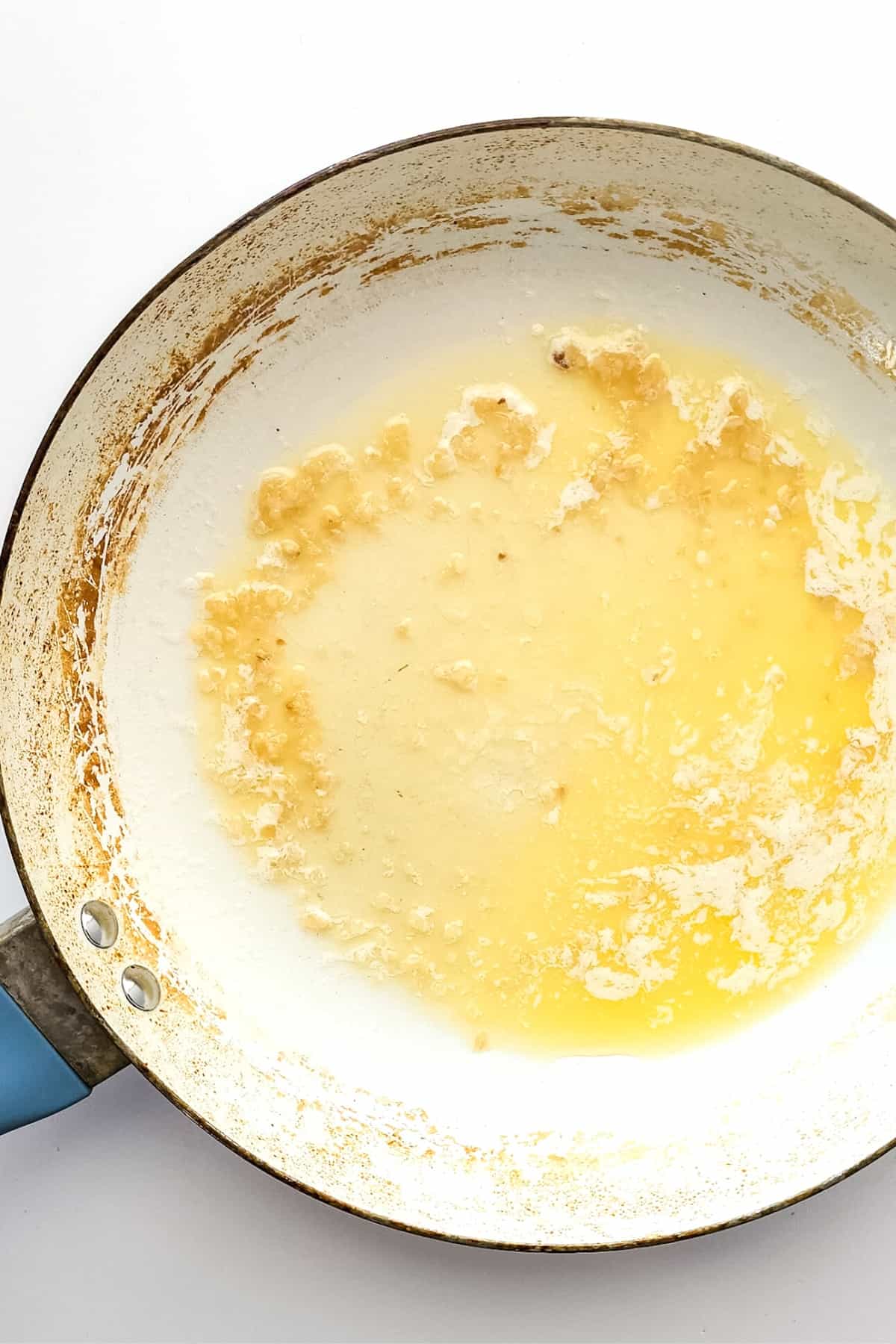 Sautéing minced garlic in butter.