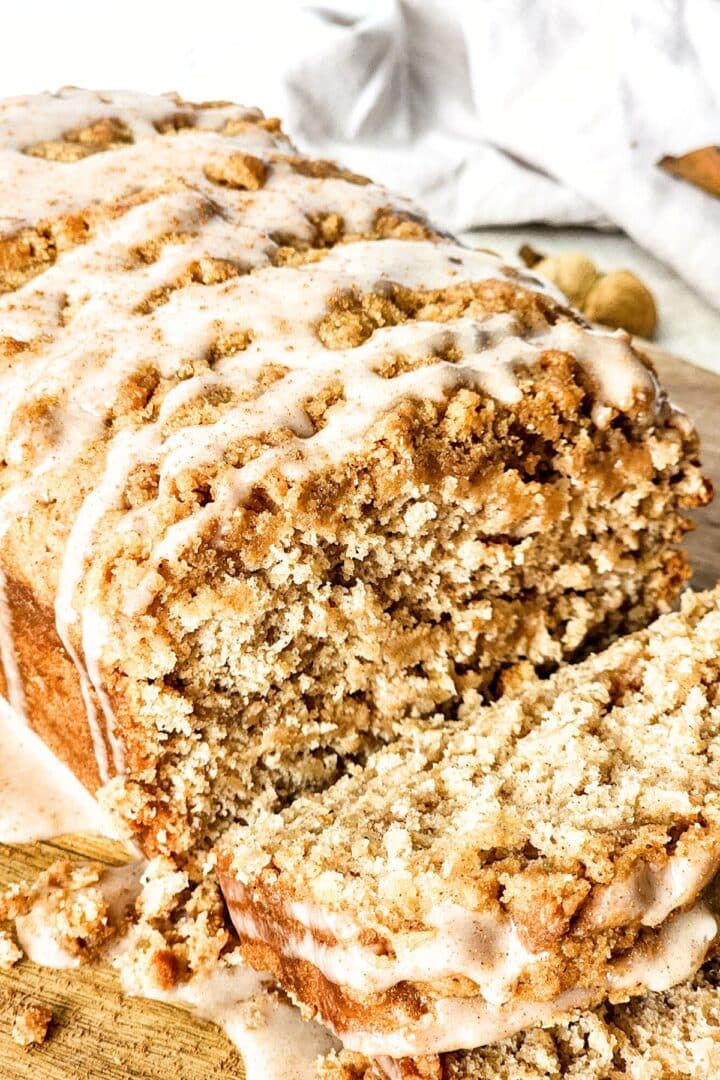 Sliced apple loaf drizzled in glaze.