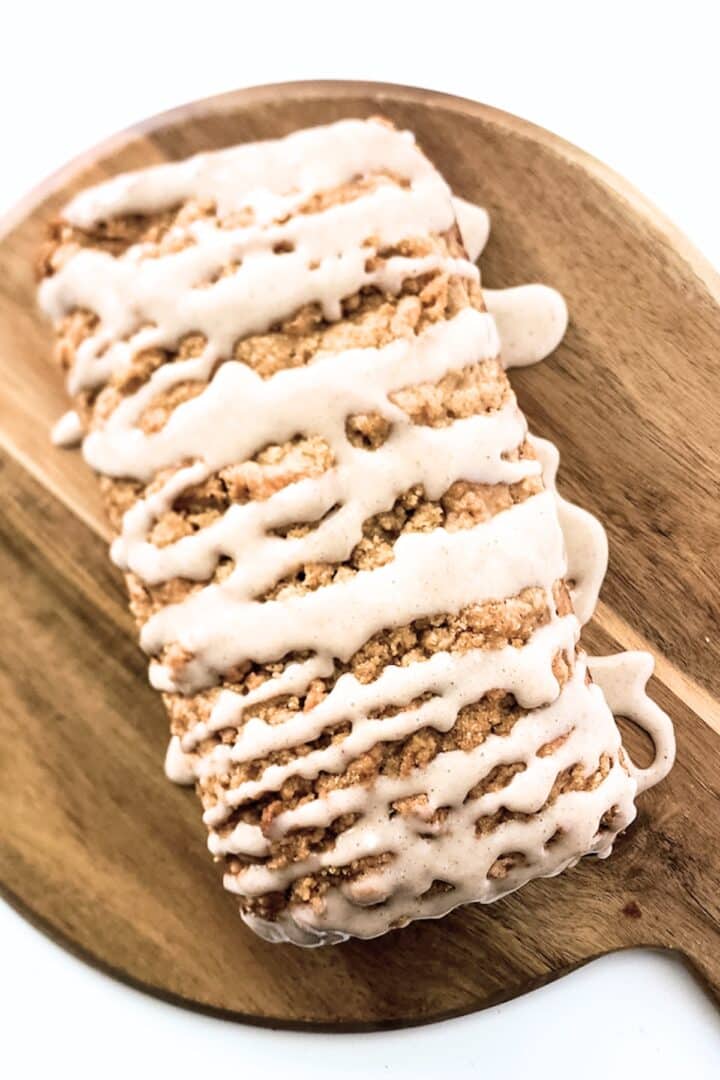 Cinnamon glaze drizzled on top of apple loaf.
