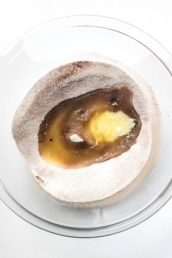Melted butter and vanilla extract on top of sugar mixture.