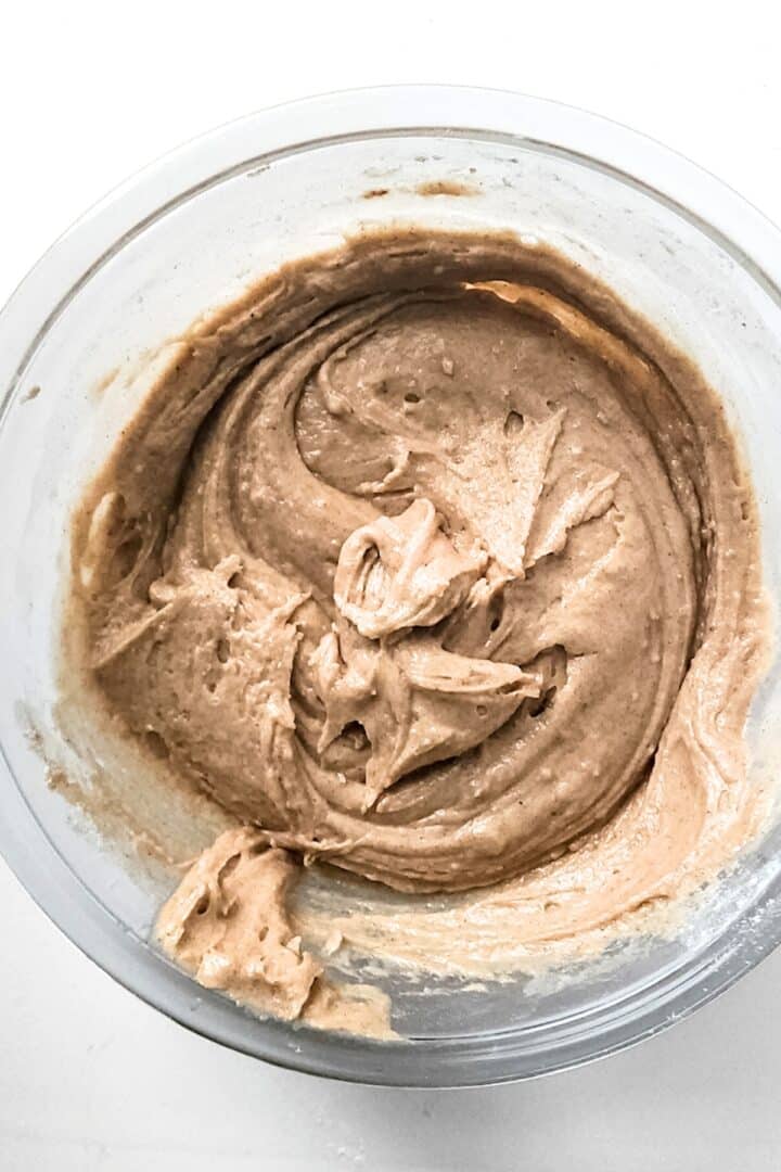 Pale brown cake batter in mixing bowl.