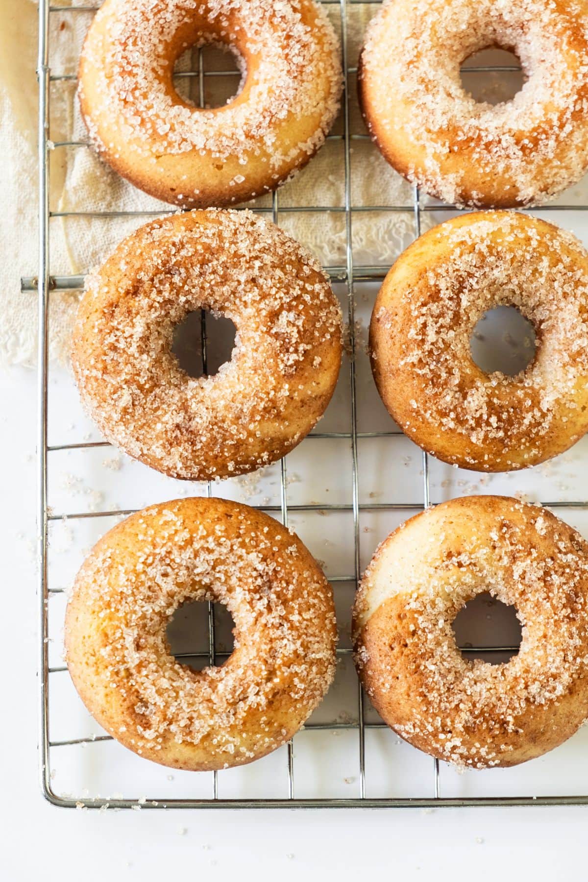 Sugar-coated donuts on wire rack