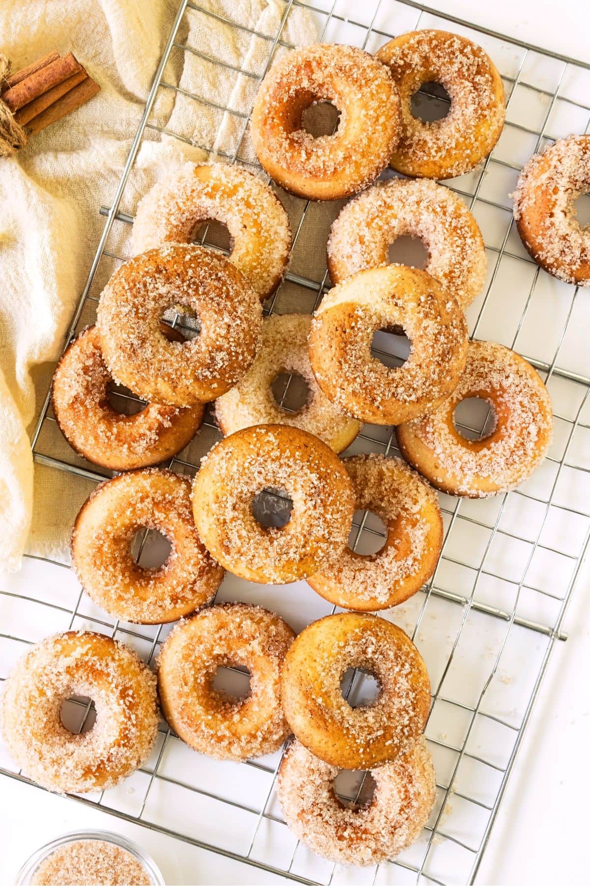 Top down view of gluten-free cider donuts on wire rack