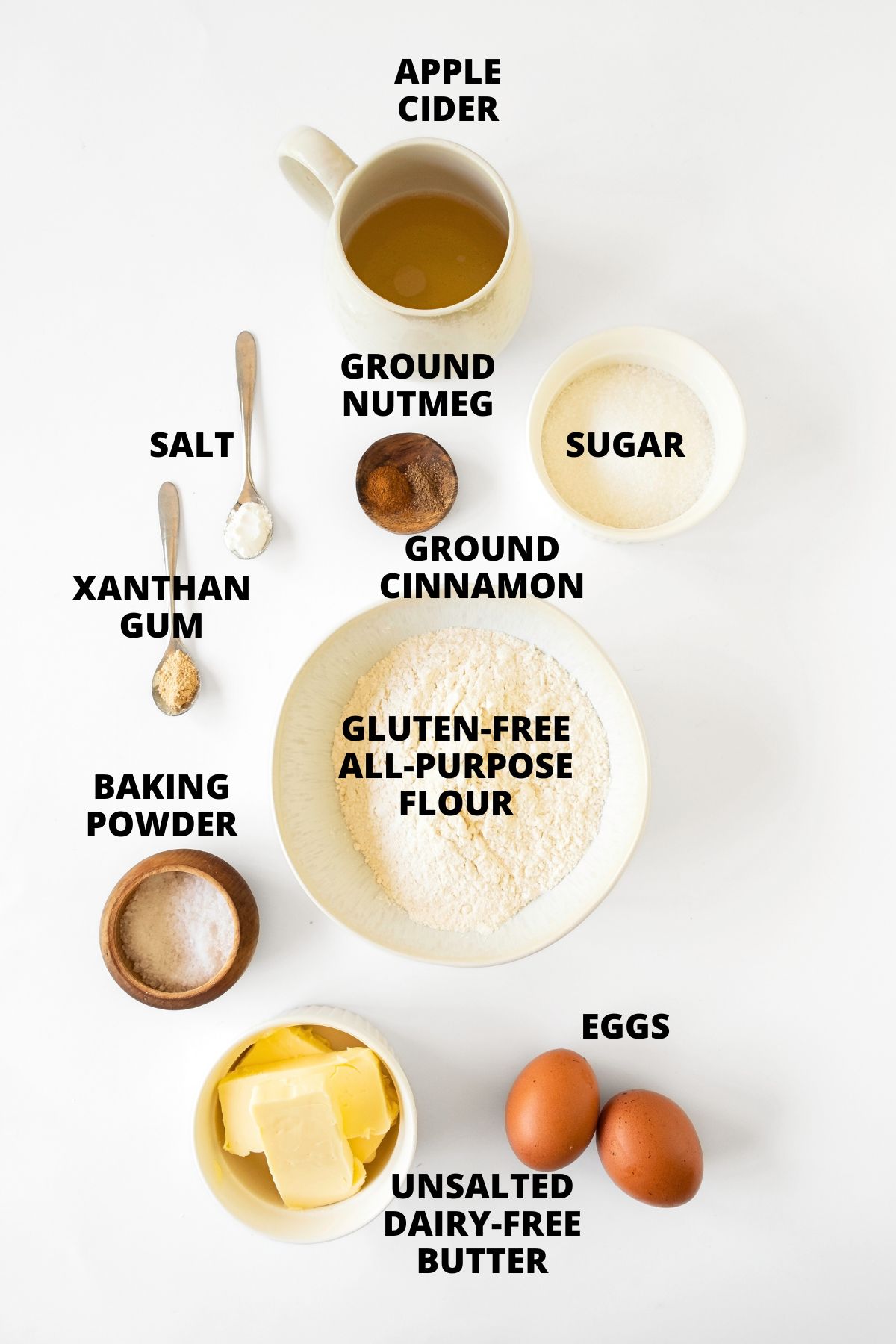 Ingredients for gluten-free apple cider donuts recipe laid out on white board.