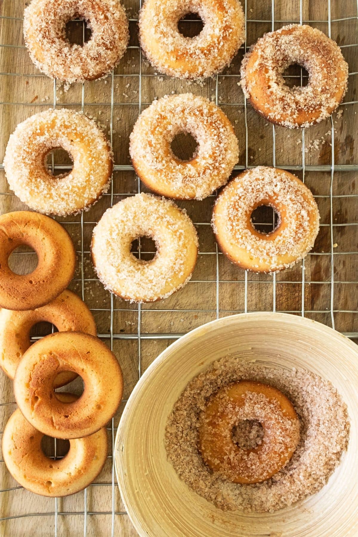 Coating donuts in cinnamon-sugar mixture