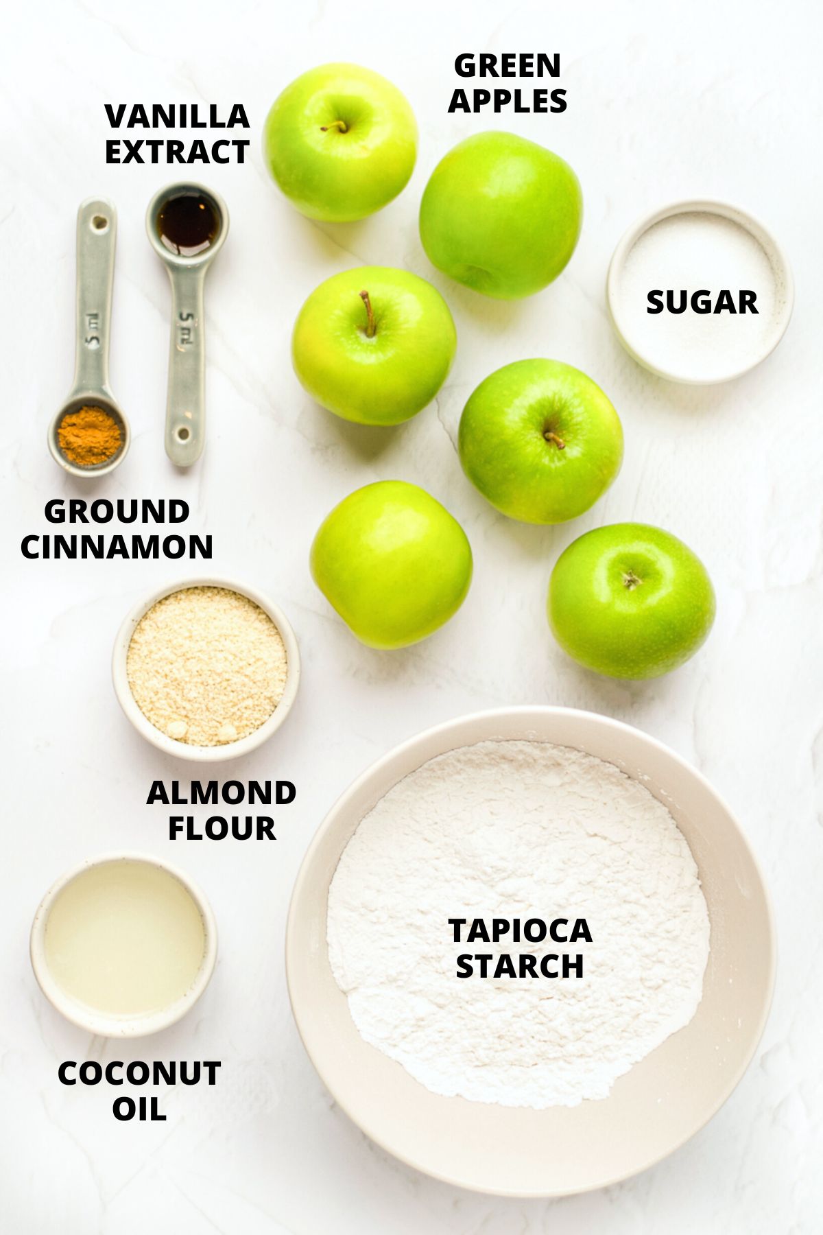 Ingredients required for gluten-free apple crumble recipe on marble board.
