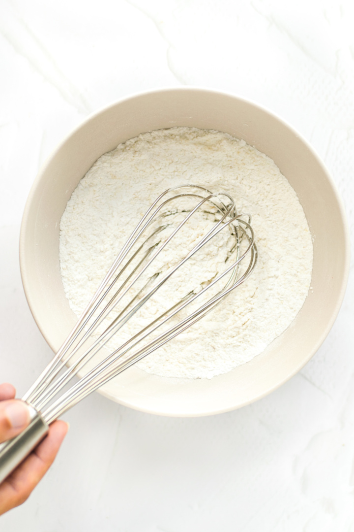 Whisking flour mixing in bowl.