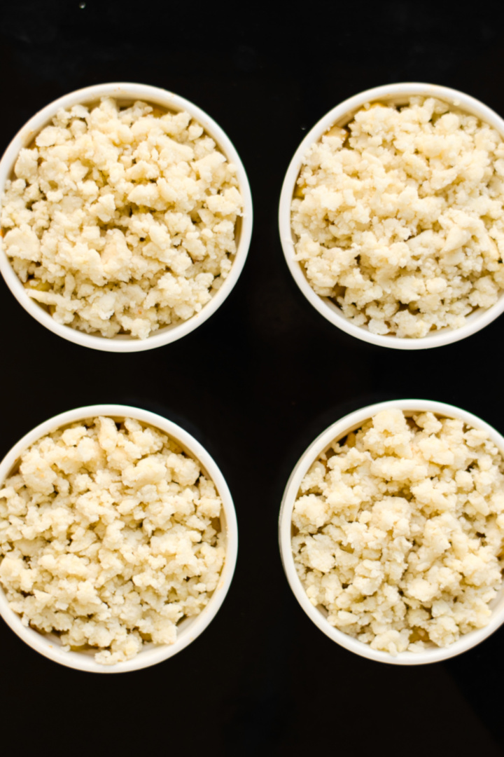 Crumble mixture in ramekins ready to be baked.