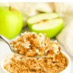 Scooping up a spoonful of apple crumble.
