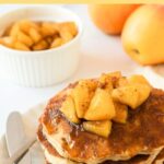 A plate of apple pancakes and apples in the background
