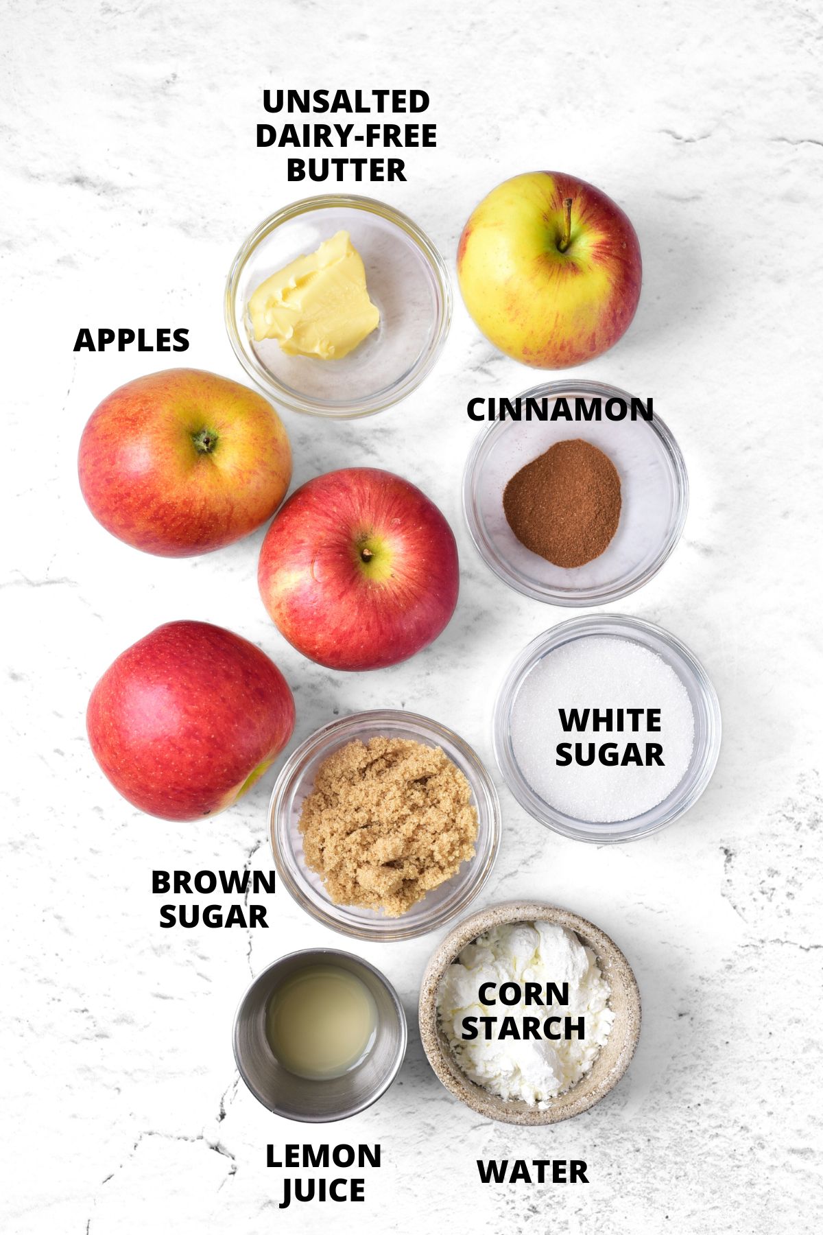 Ingredients for gluten-free apple pie filling recipe laid out on board.