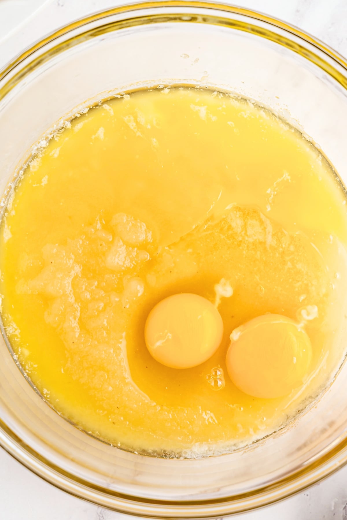 Yellow mixture with eggs in glass bowl