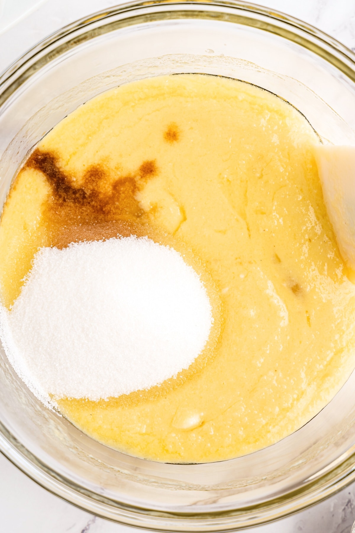 Mixing muffin batter in glass bowl.