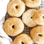 Top down view of gluten-free bagels on wire rack.