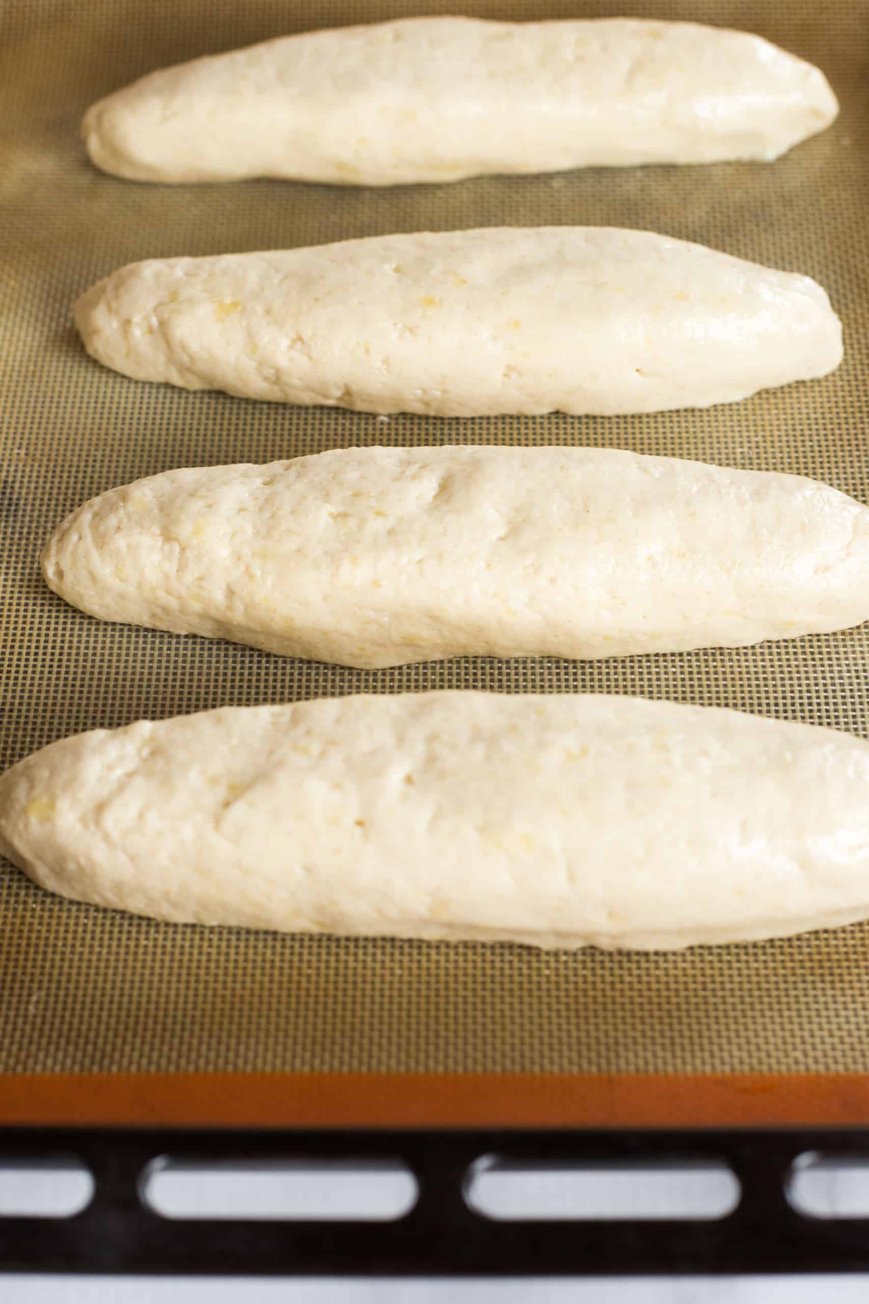Up close shot of gluten free baguette dough on baking sheet.