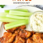 A plate of buffalo wings and celery sticks