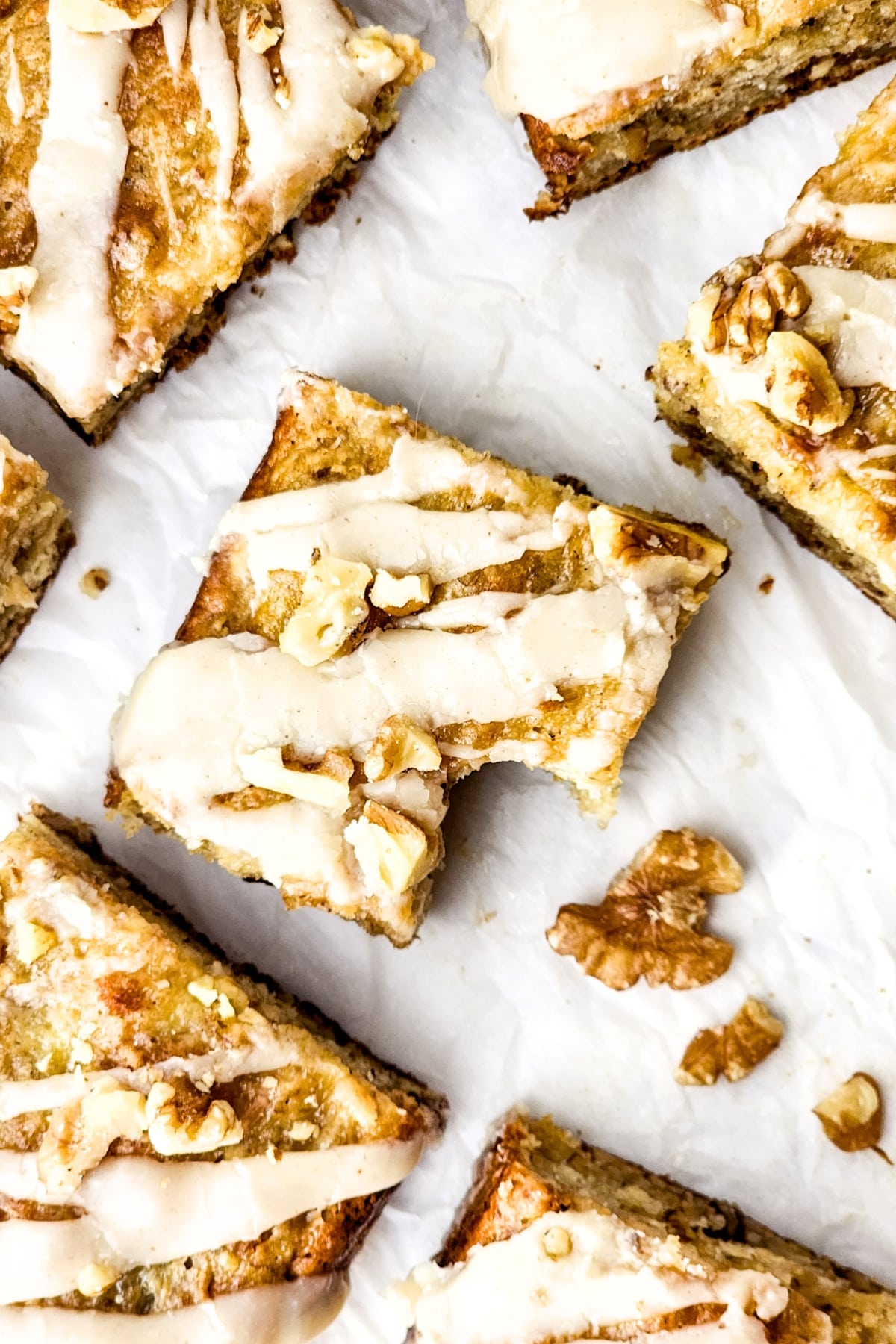 Half-eaten gluten-free banana bread squares on parchment.