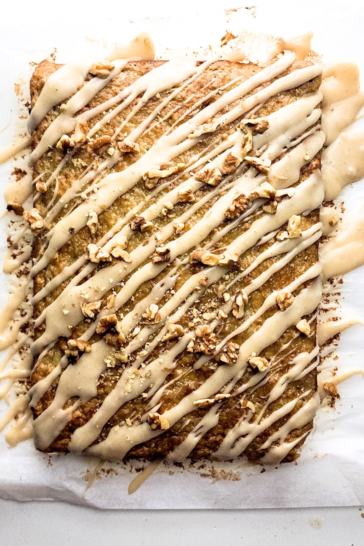 Glazed banana cake topped with walnuts.