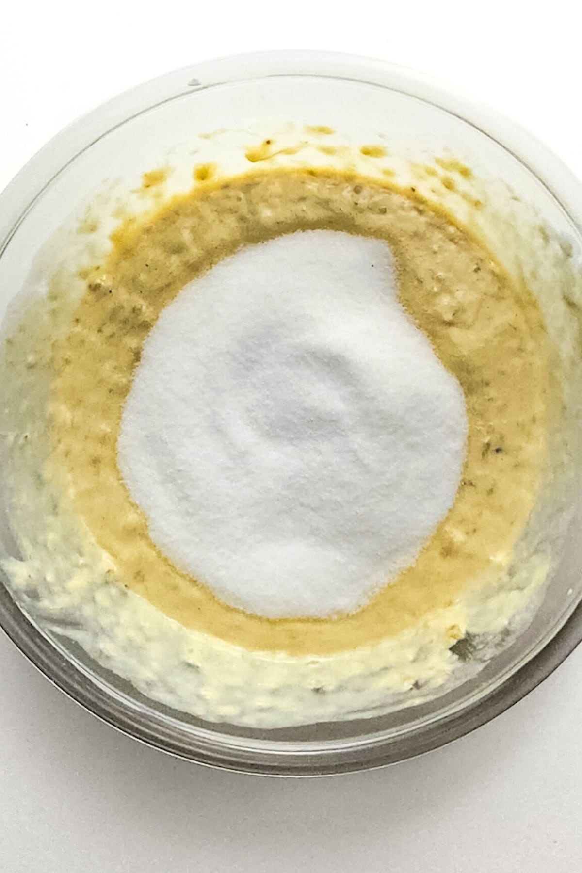 Sugar on top of pale yellow mixture.