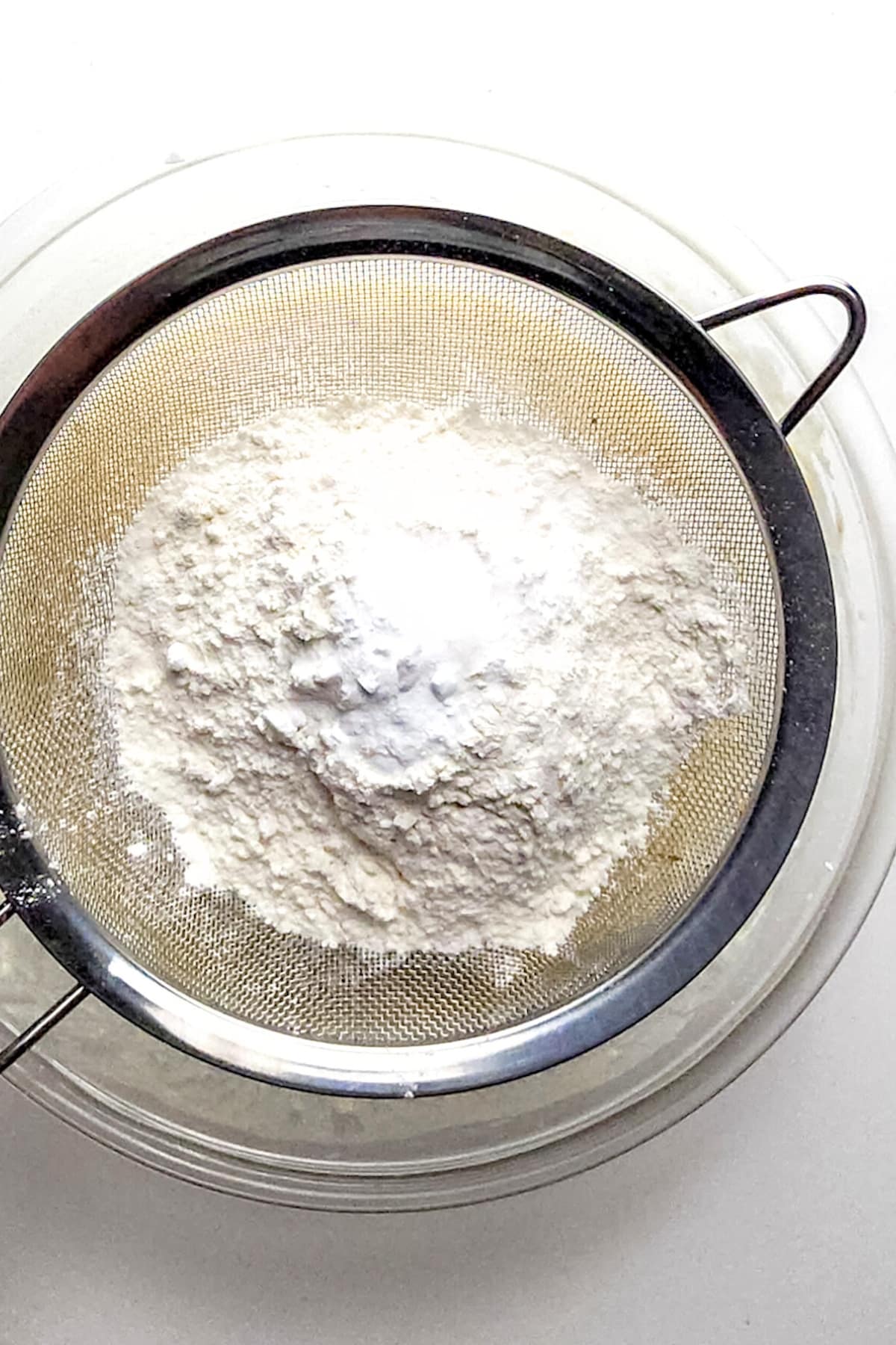 Whisking dry ingredients into glass bowl.