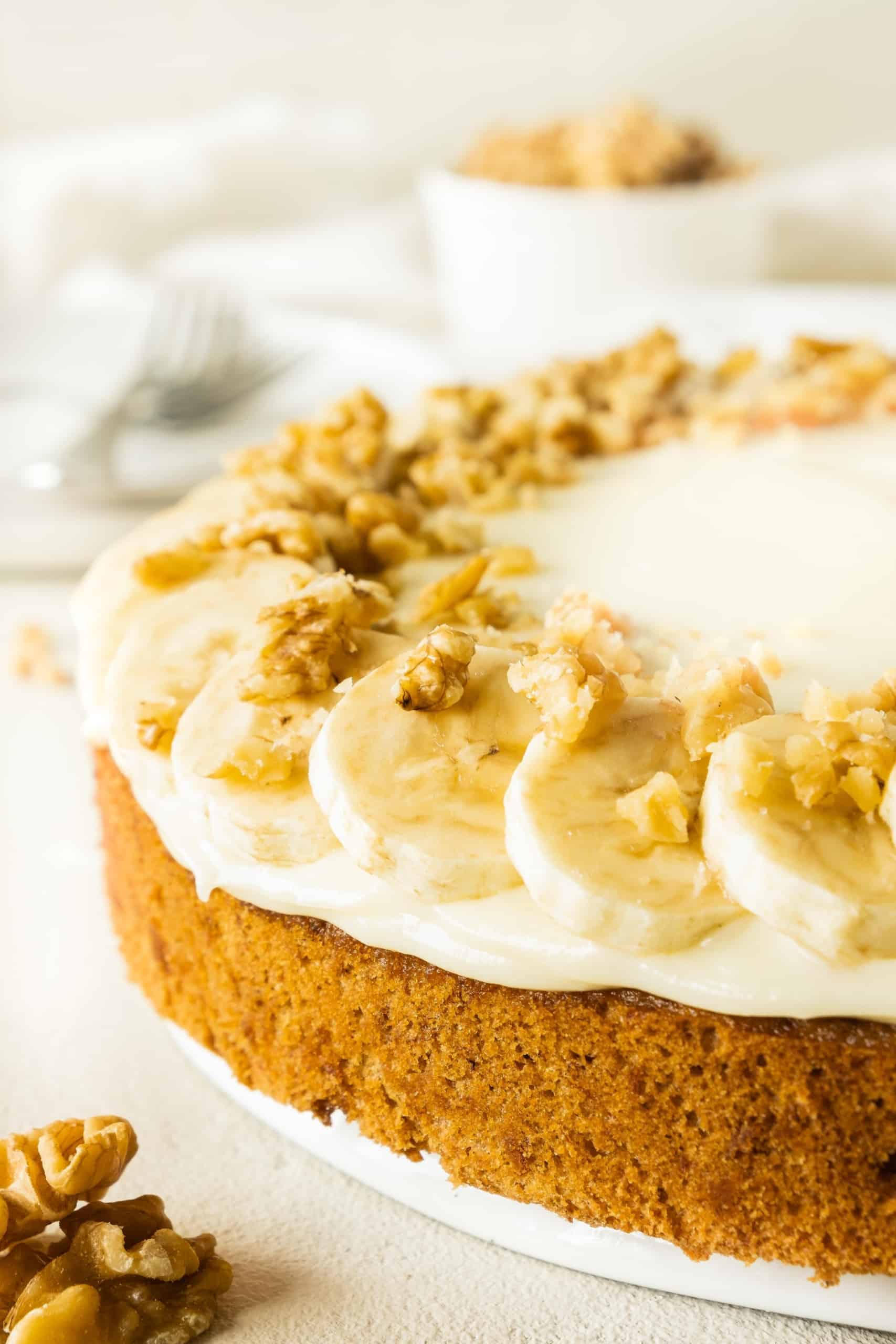 Up close shot of gluten-free banana cake with cream cheese frosting.