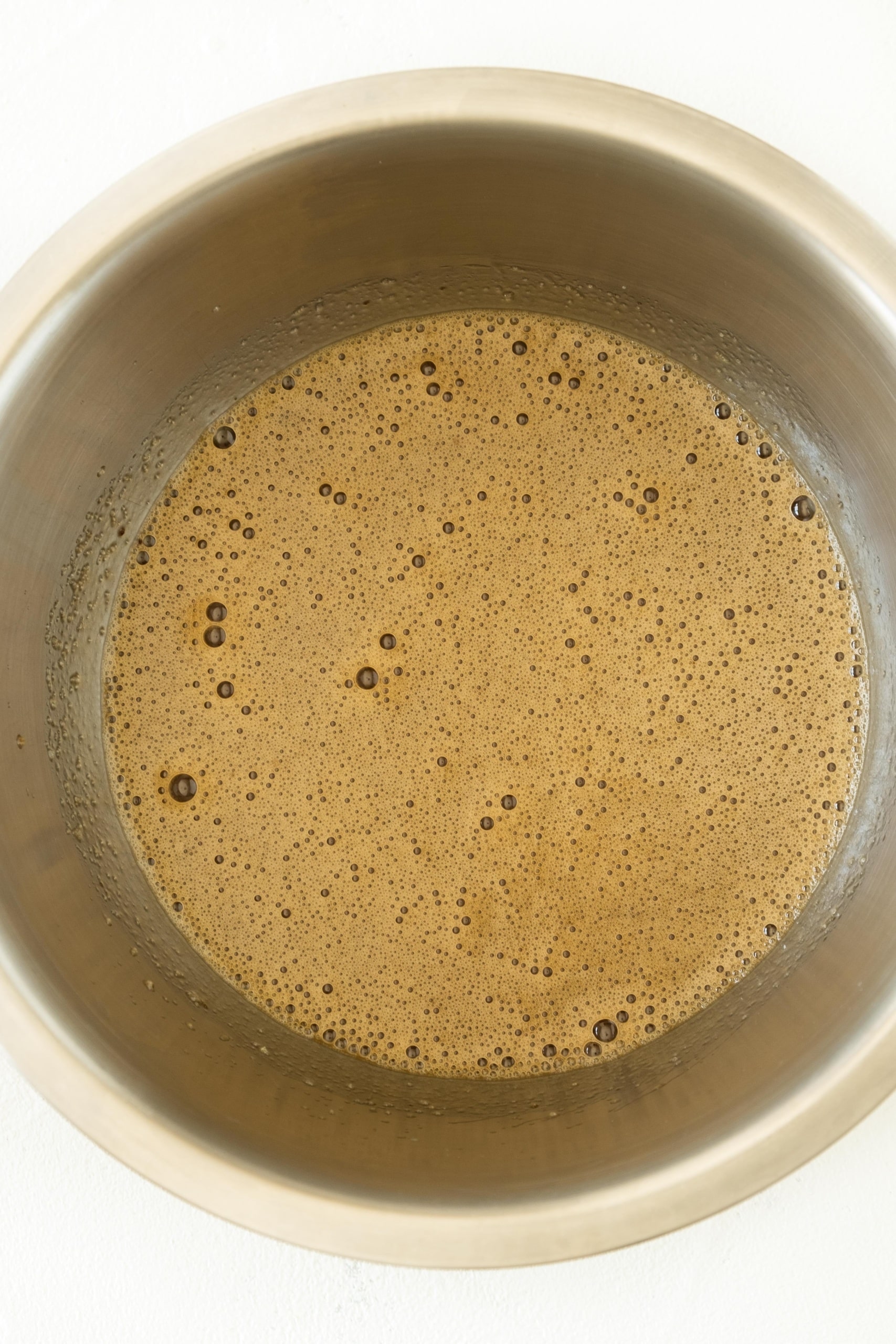 Light brown foamy mixture in metal bowl.