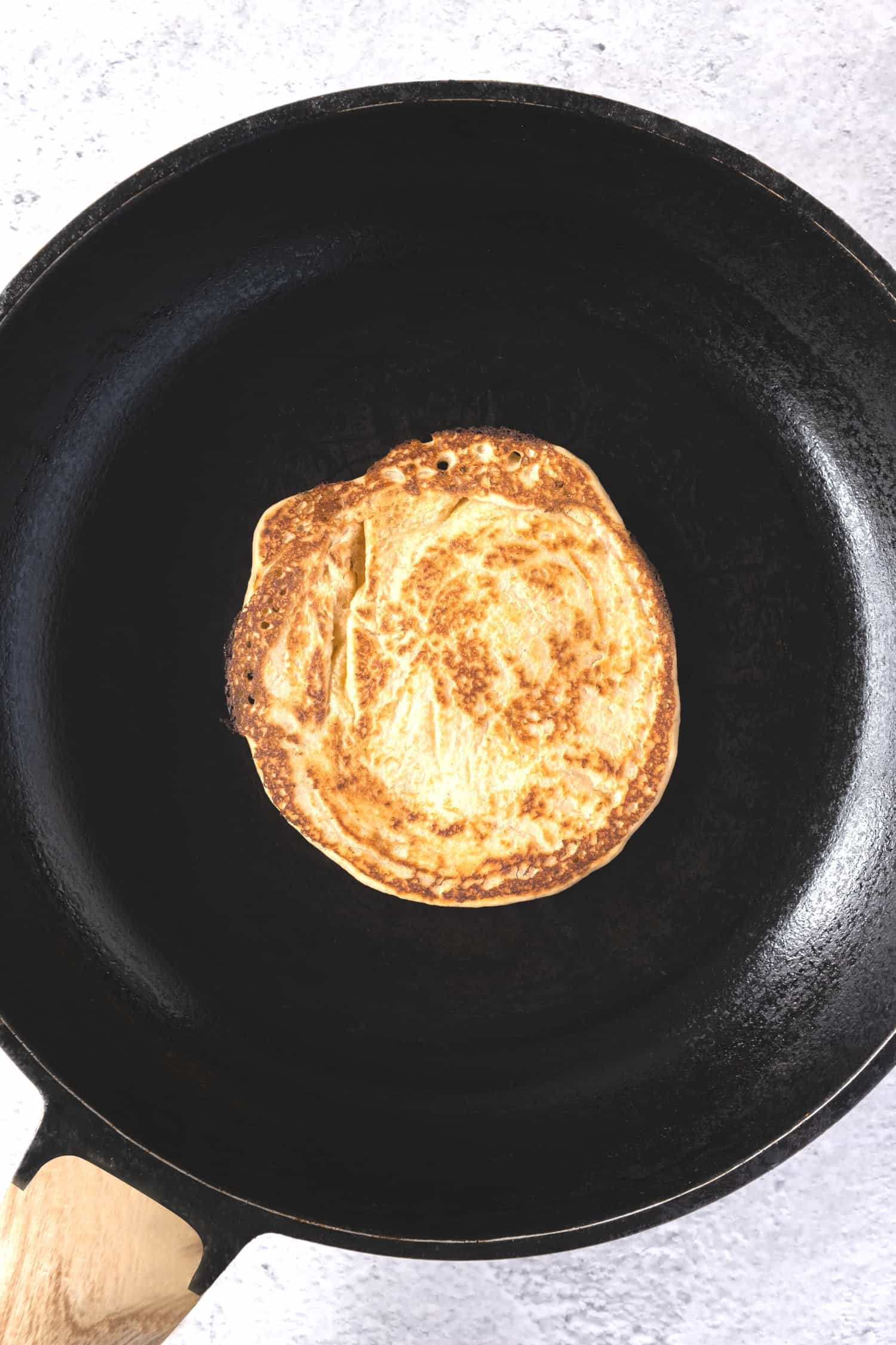 Cooking a pancake in a skillet.