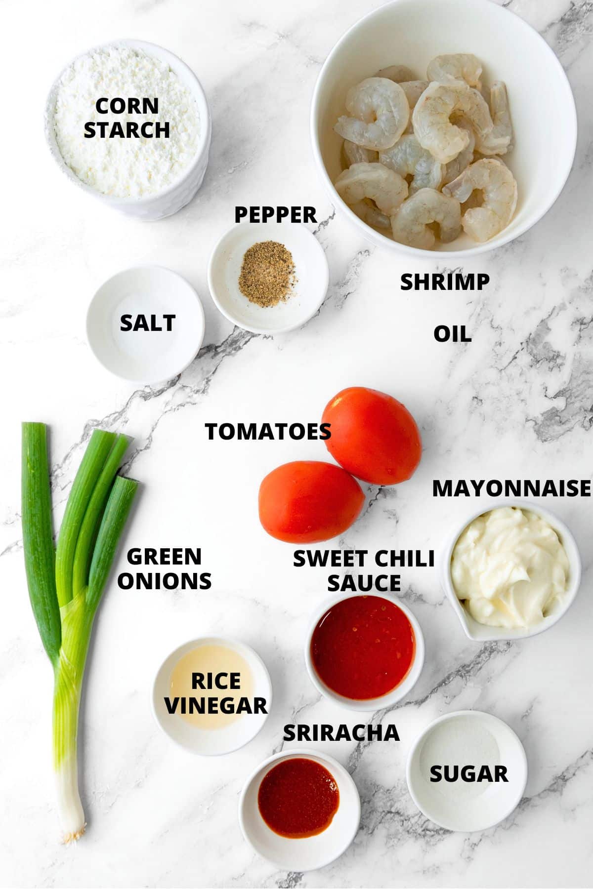 Ingredients for gluten-free fried shrimp recipe laid out on marble board.
