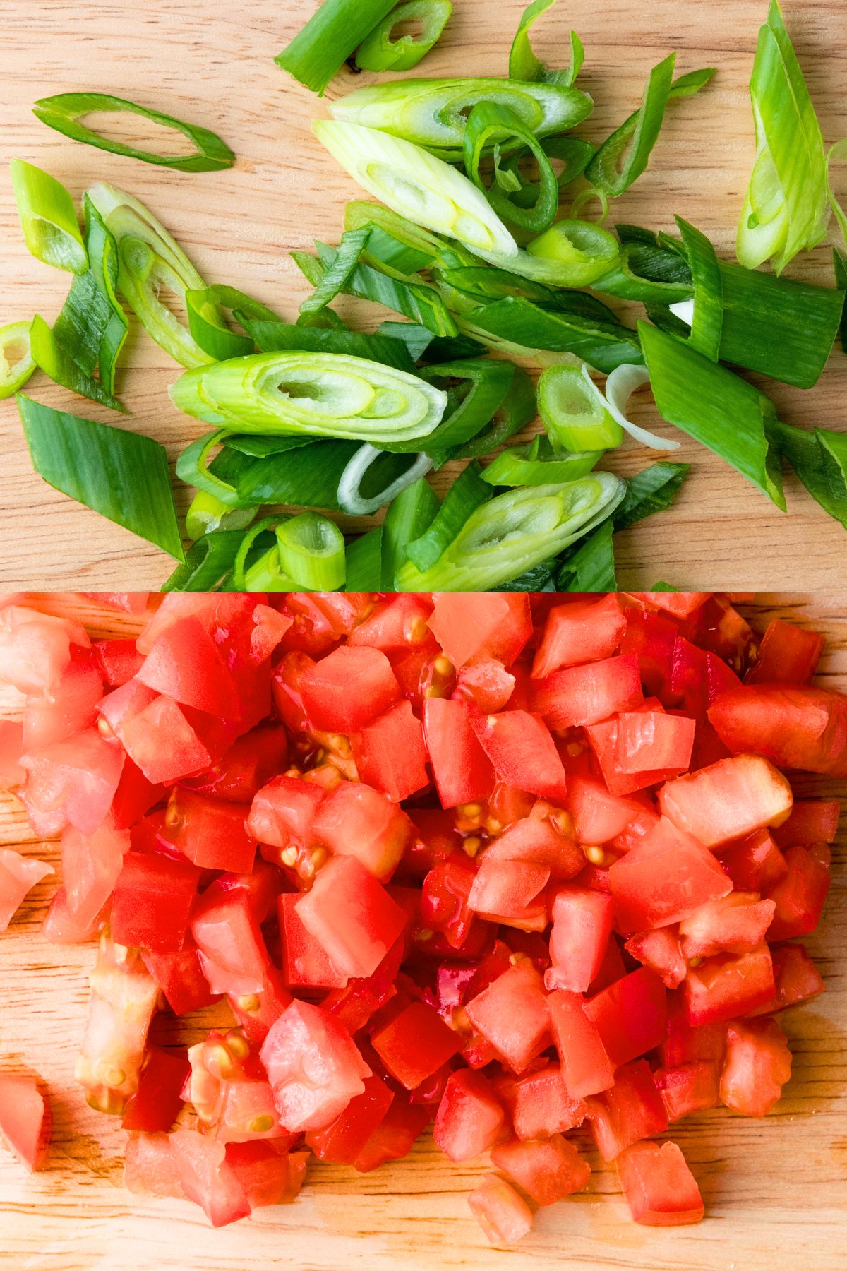 Sliced spring onions and diced tomatoes on wooden board.