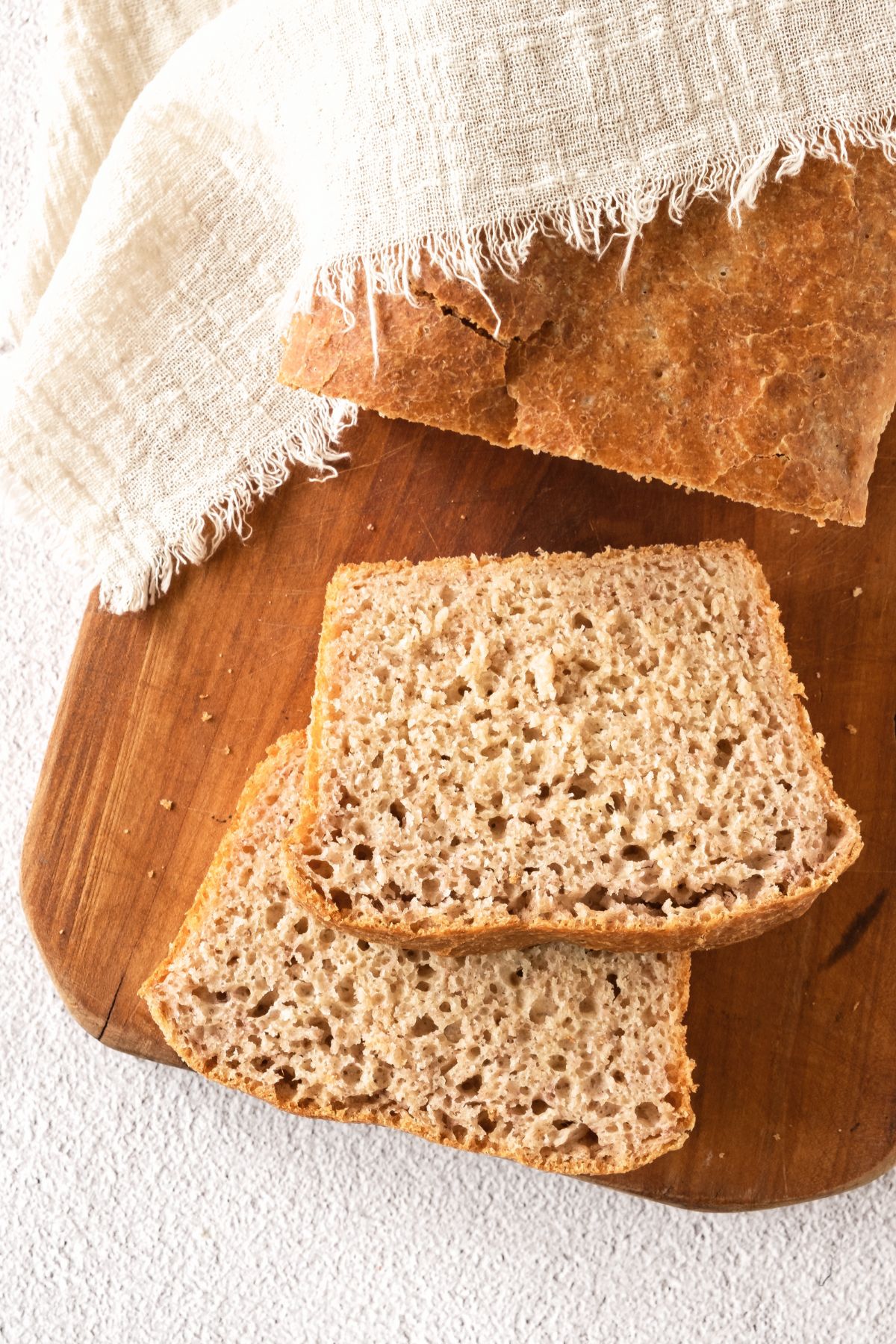 Up close view of slices of gf beer bread on wooden board