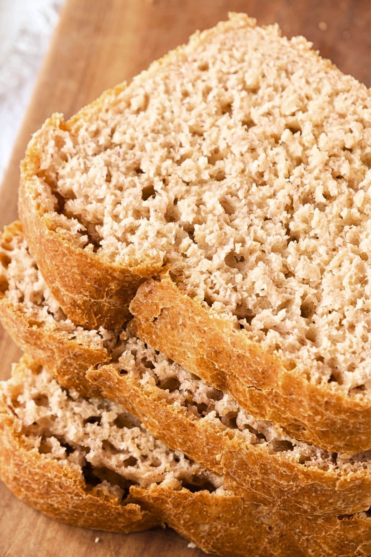 Slices of gf beer bread on wooden board.